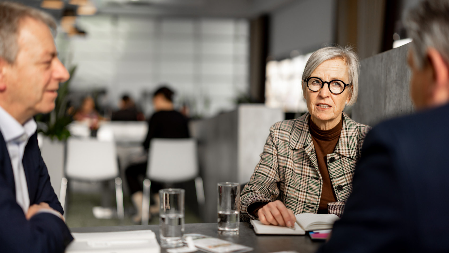 a woman and two men at a table