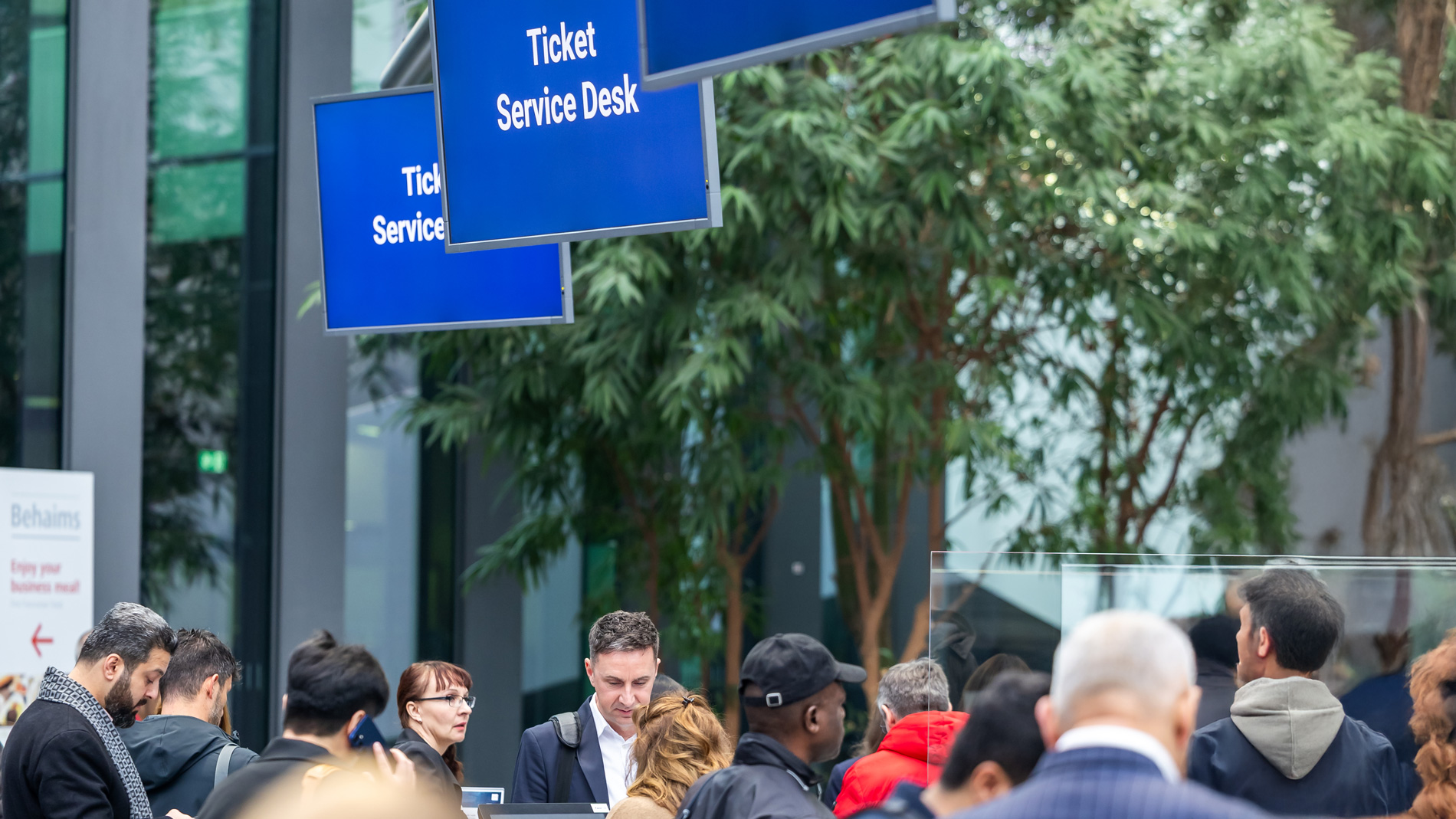 Besucher am Ticket Service Desk der SPS Messe in Nürnberg bei der Ankunft und Registrierung.