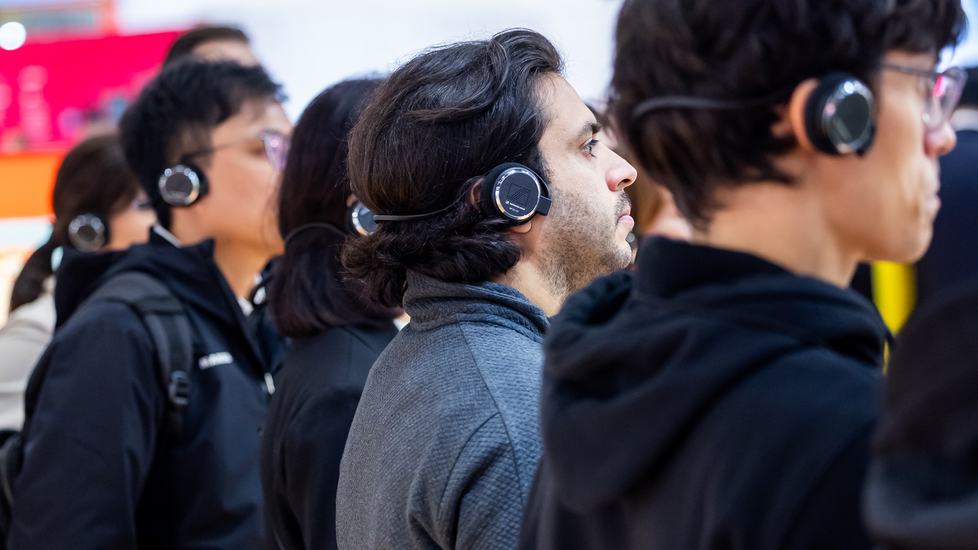 An international group of young trade show visitors listens attentively to a presentation during the SPS Guided Tours.